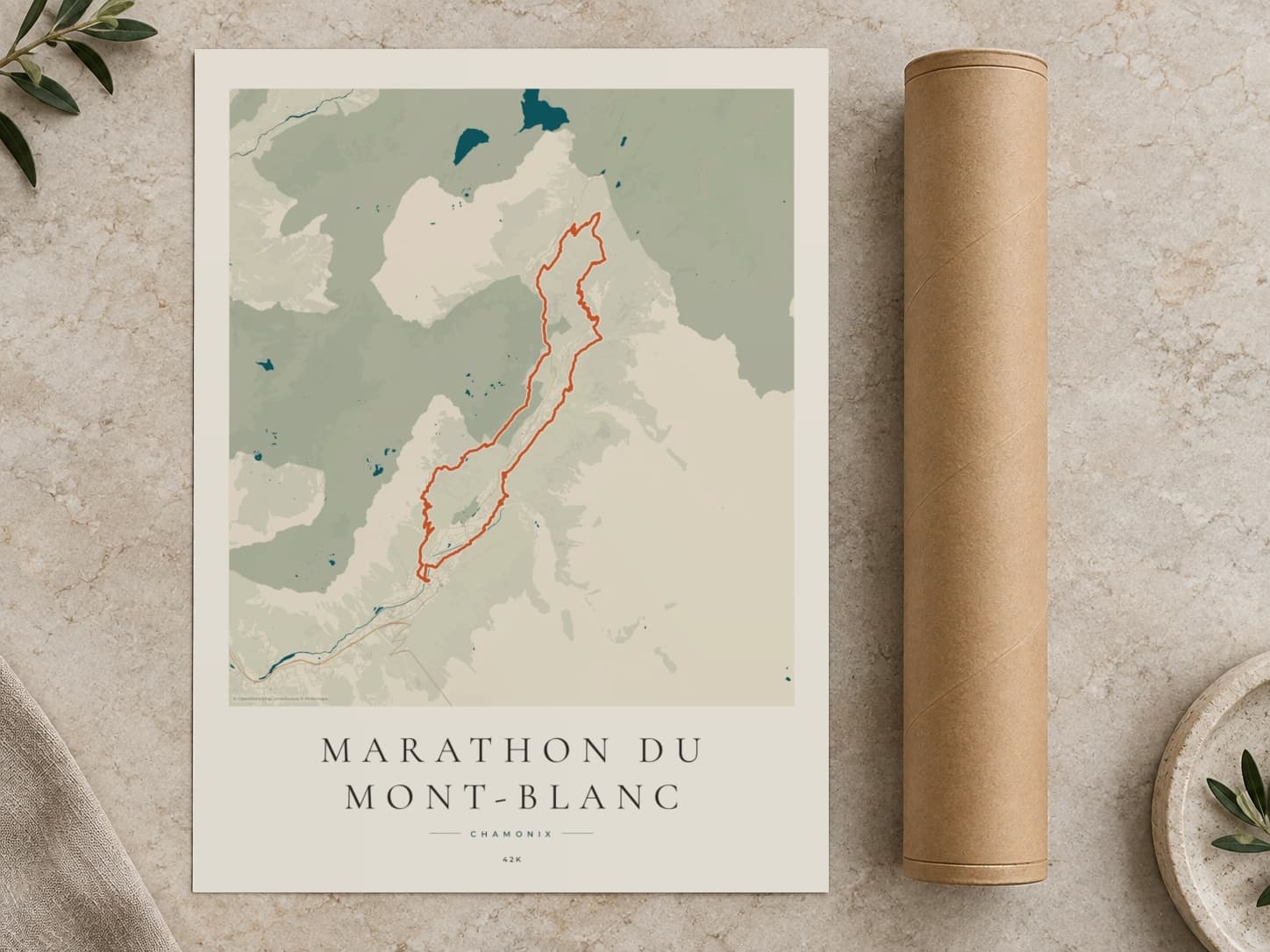 Cardboard postal tube beside a flat Marathon du Mont-Blanc route print
