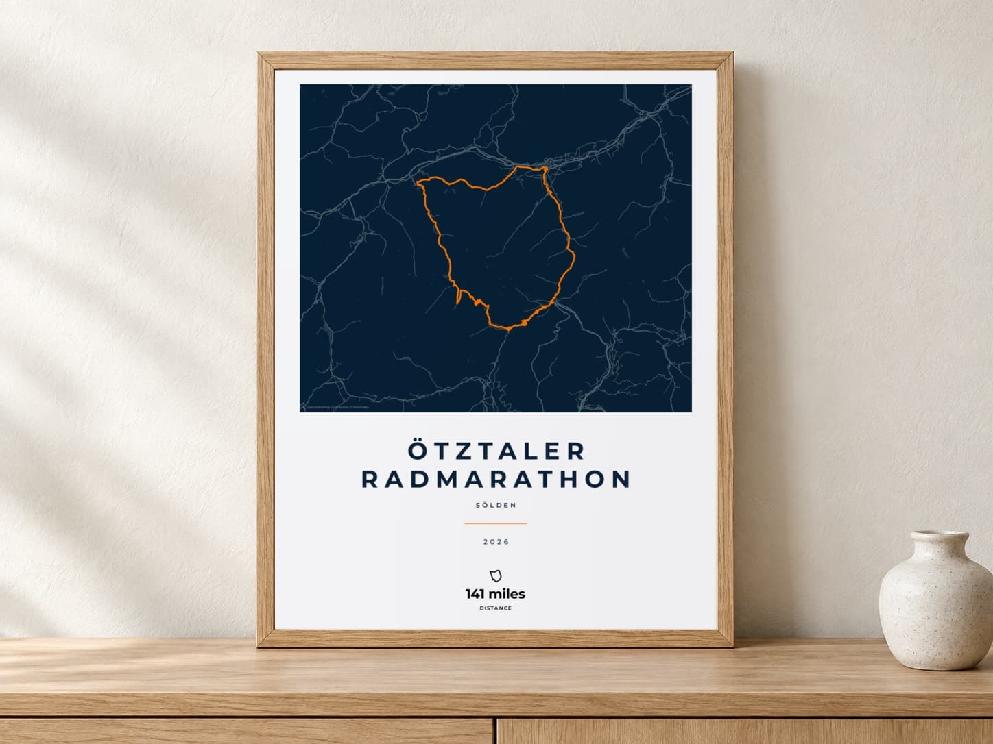 Ötztaler Radmarathon 2026 Race Blueprint route print in a light oak frame on a console