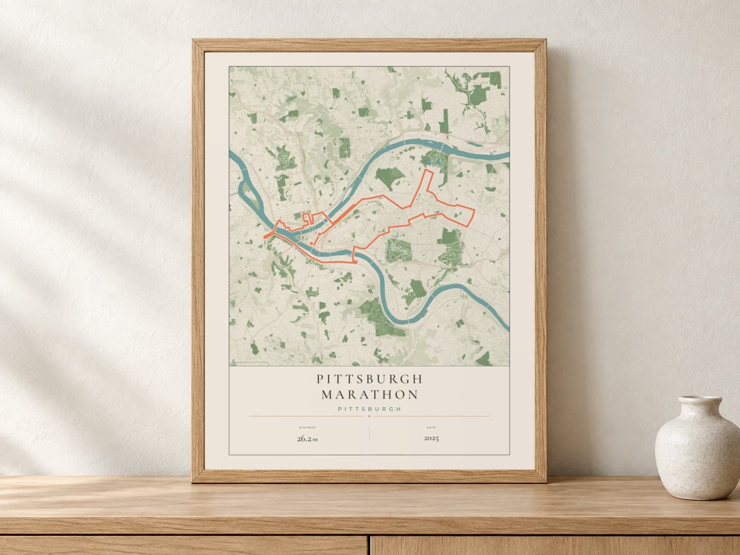 Pittsburgh Marathon 2025 Parkland route print in a light oak frame on a console