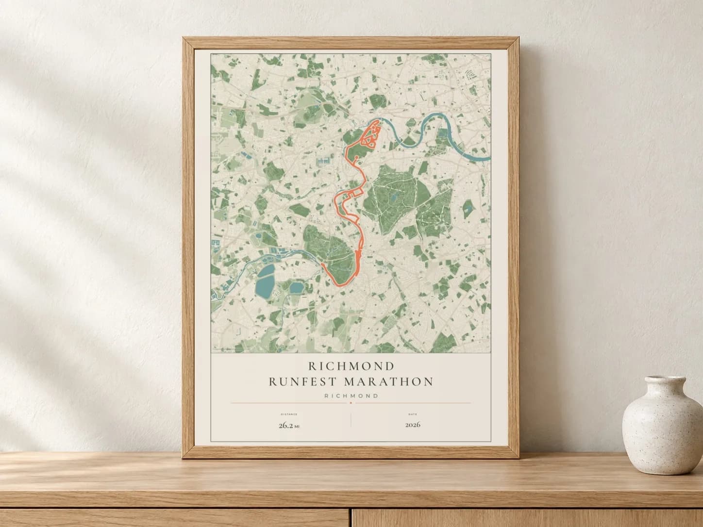 Richmond RUNFEST Marathon 2026 Parkland route print in a light oak frame on a console