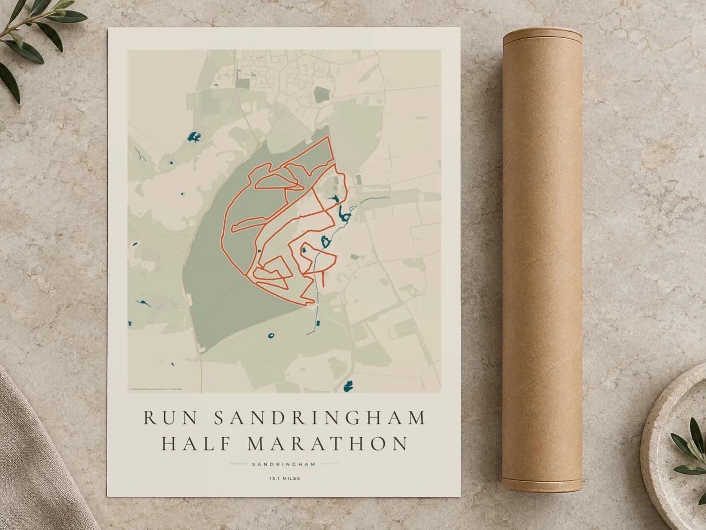 Cardboard postal tube beside a flat Run Sandringham Half Marathon route print