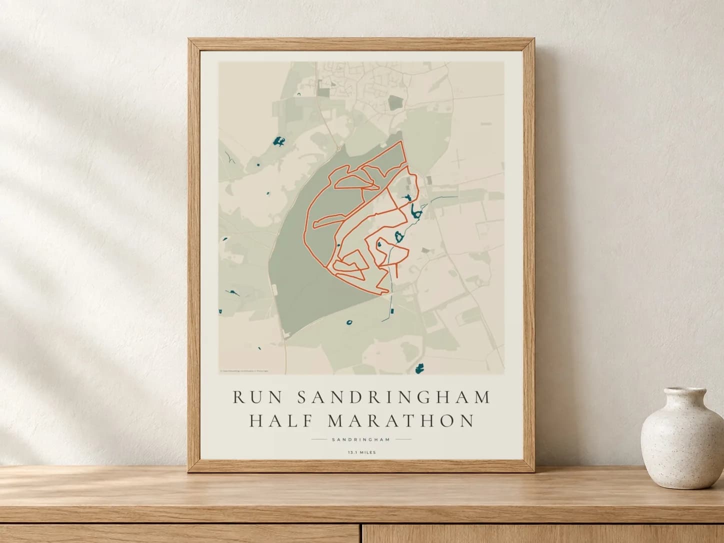 Run Sandringham Half Marathon 2025 Coastal Atlas route print in a light oak frame on a console