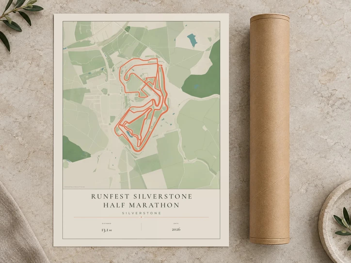 Cardboard postal tube beside a flat RunFest Silverstone Half Marathon route print