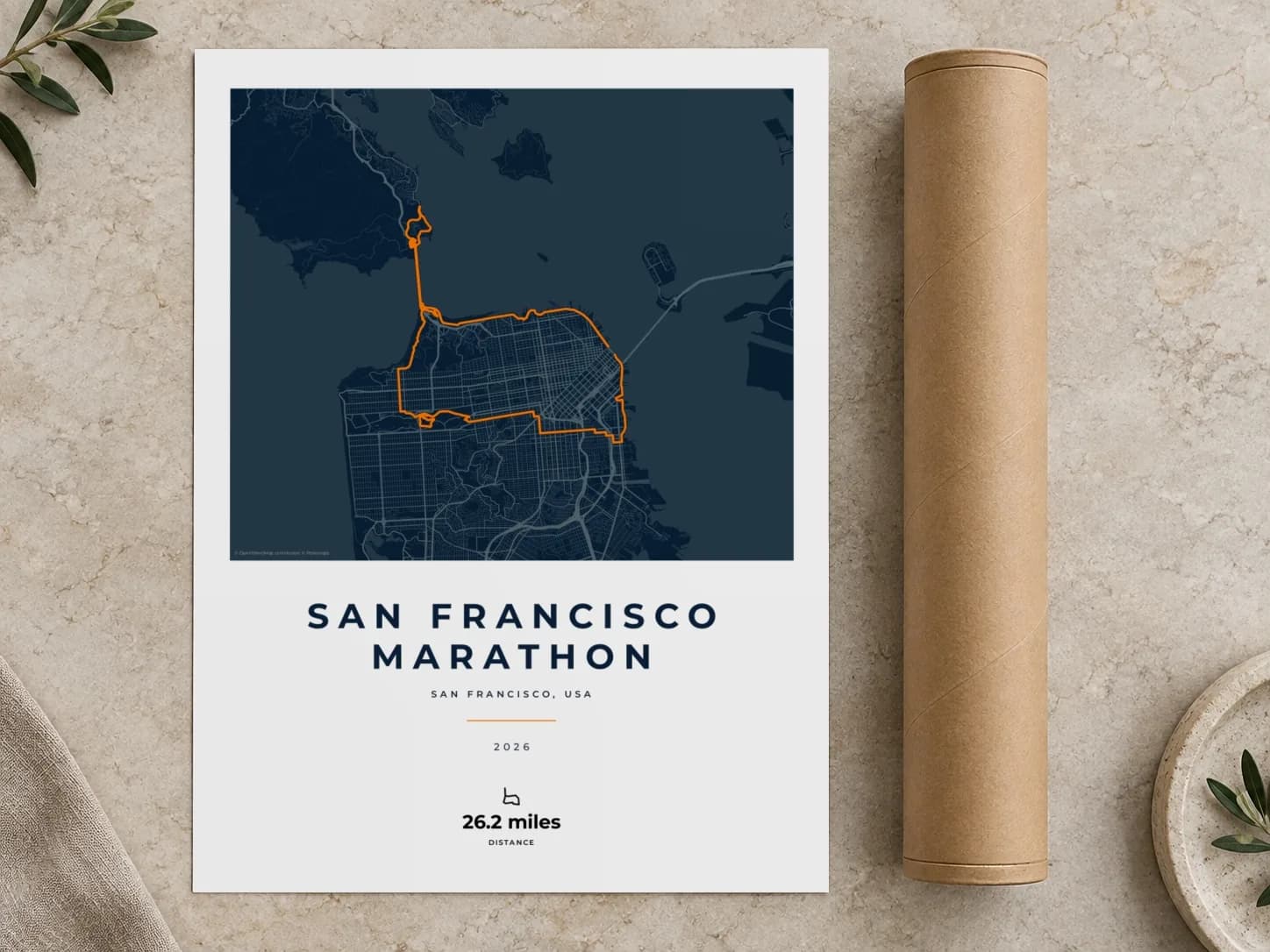 Cardboard postal tube beside a flat San Francisco Marathon route print