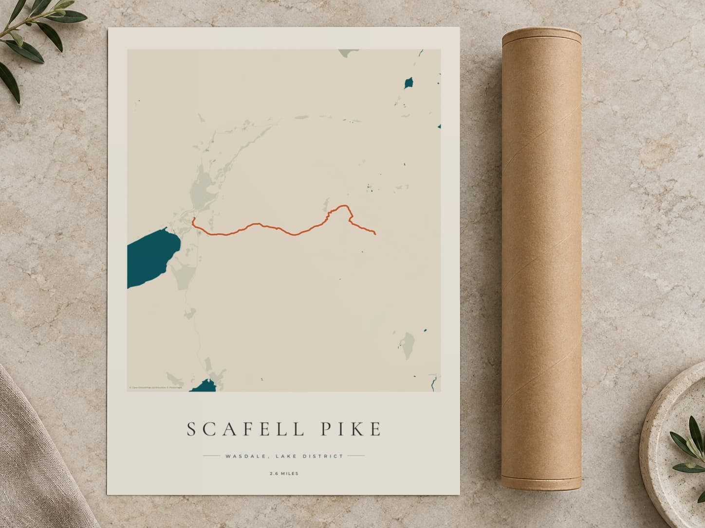 Cardboard postal tube beside a flat Scafell Pike route print