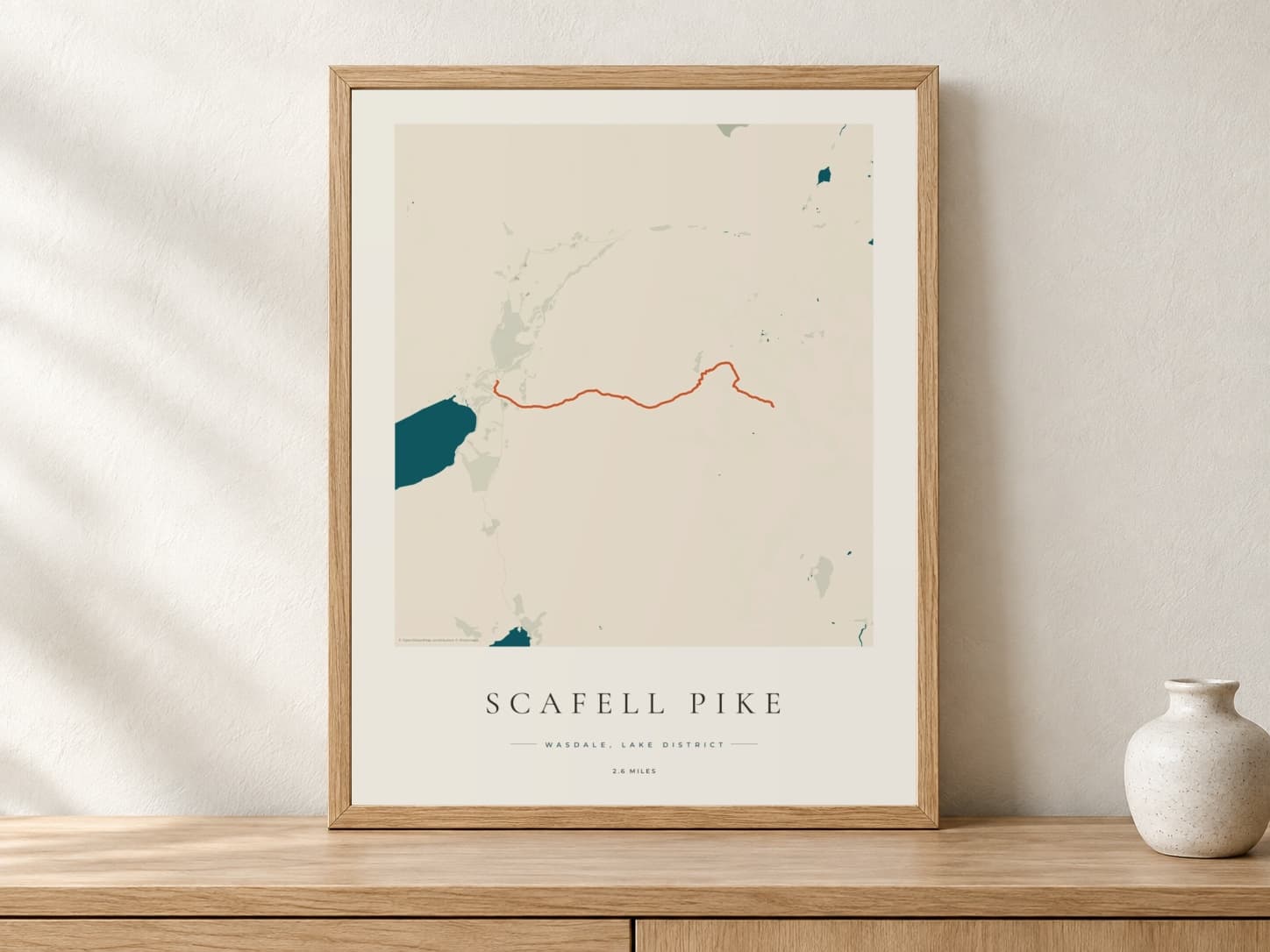 Scafell Pike Coastal Atlas route print in a light oak frame on a console