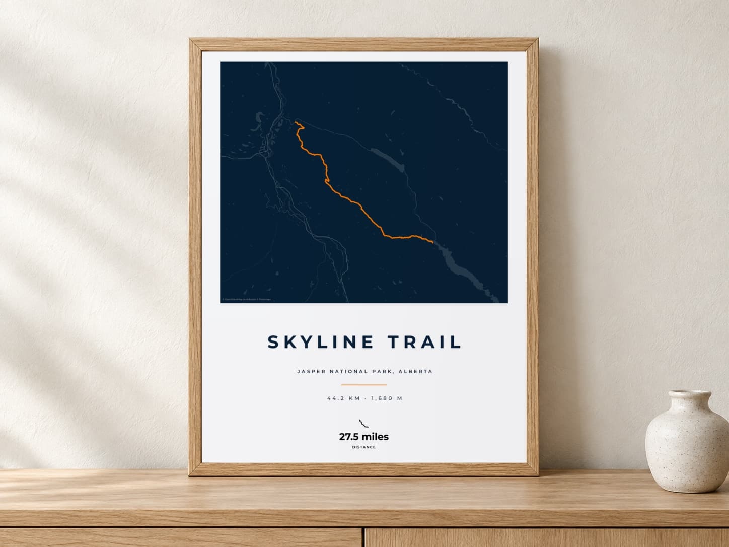 Skyline Trail Race Blueprint route print in a light oak frame on a console