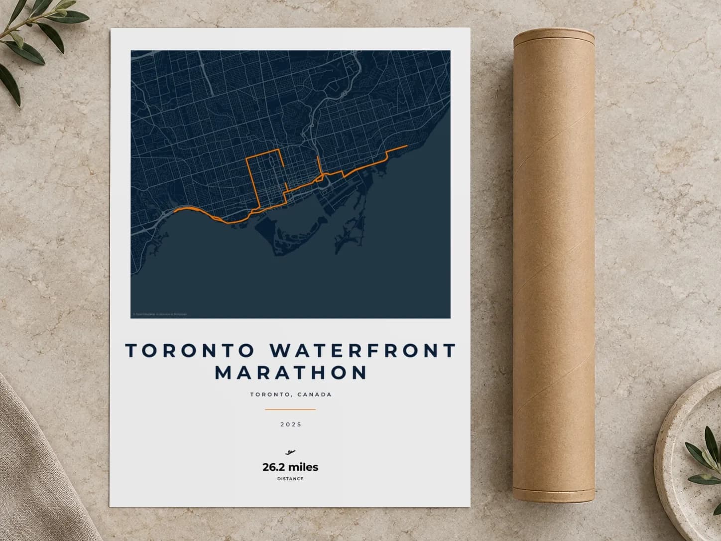 Cardboard postal tube beside a flat Toronto Waterfront Marathon route print