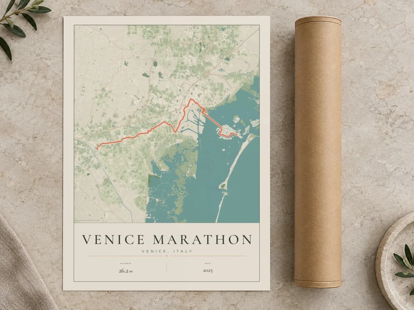 Cardboard postal tube beside a flat Venice Marathon route print