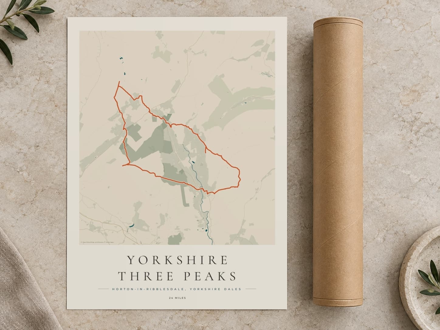 Cardboard postal tube beside a flat Yorkshire Three Peaks route print