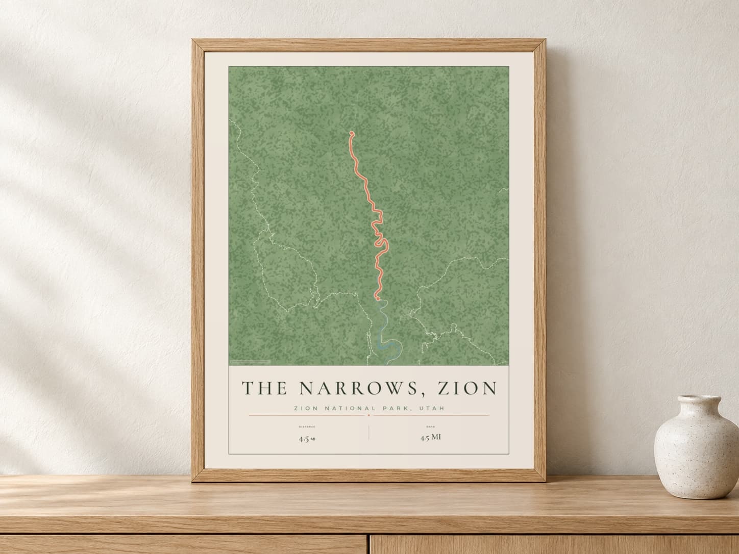 The Narrows, Zion Parkland route print in a light oak frame on a console