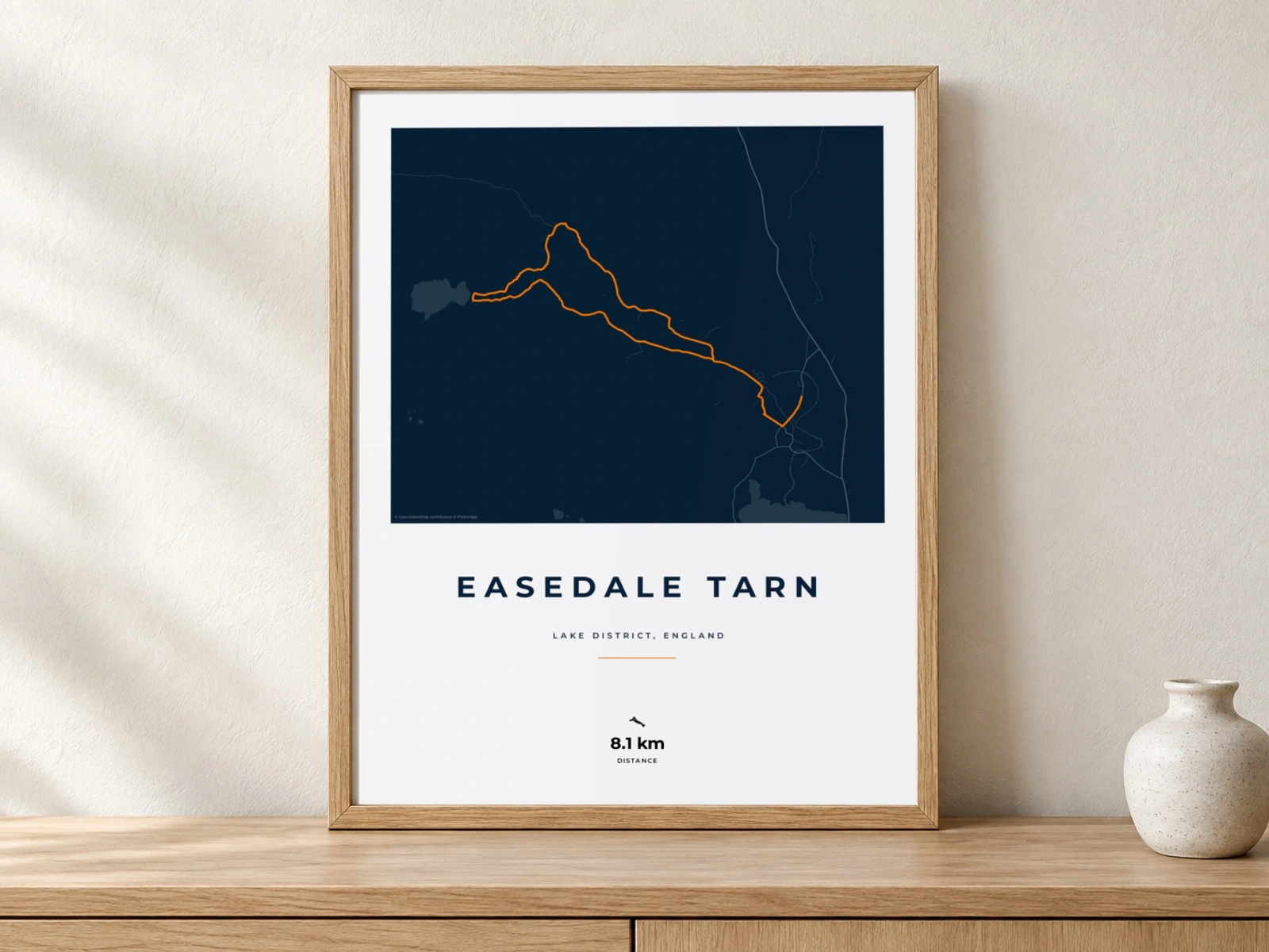 Easedale Tarn hiking print in an oak frame against a quiet plaster wall