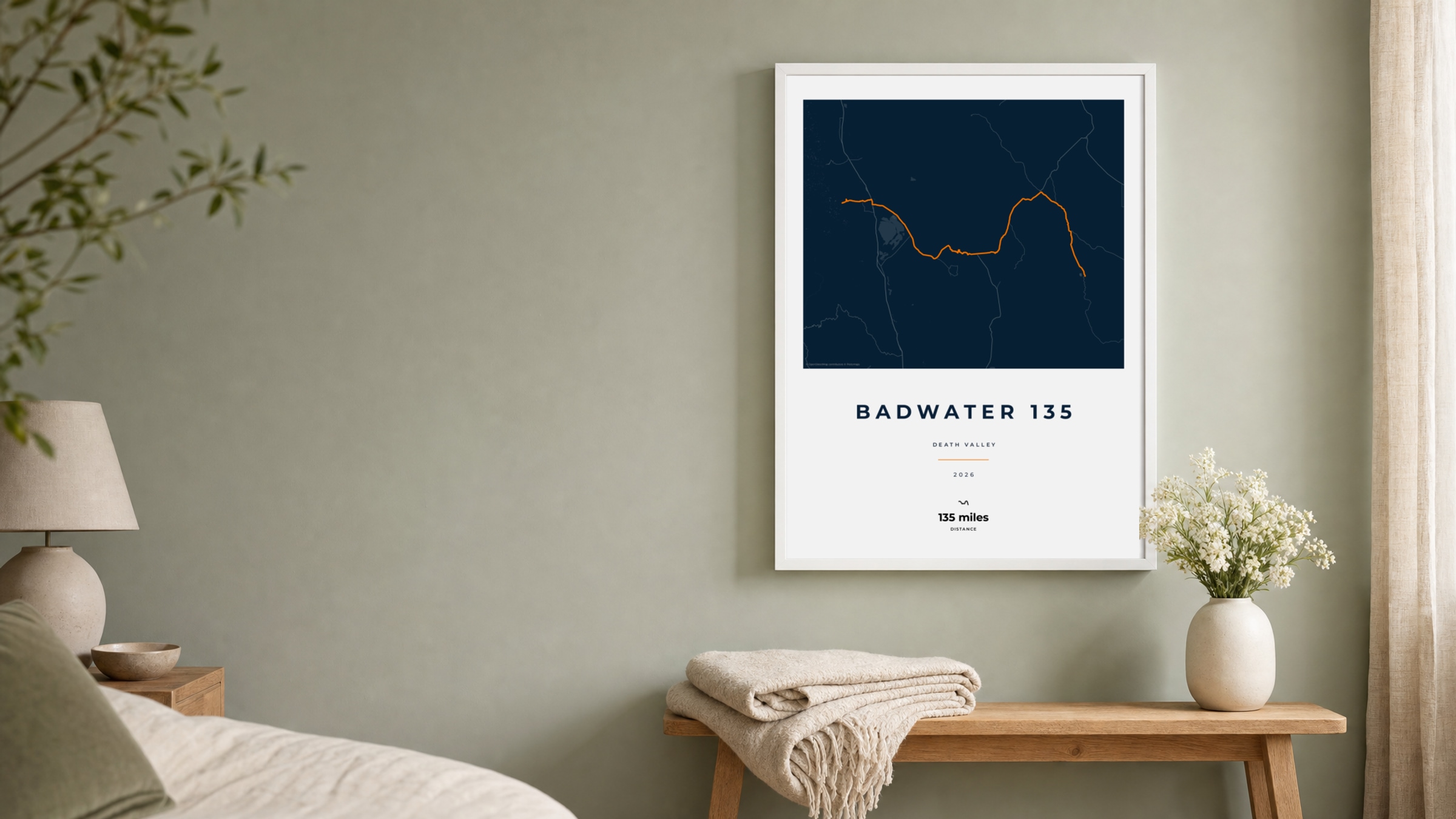 Badwater 135 2026 Race Blueprint route print in a white frame on a sage bedroom wall