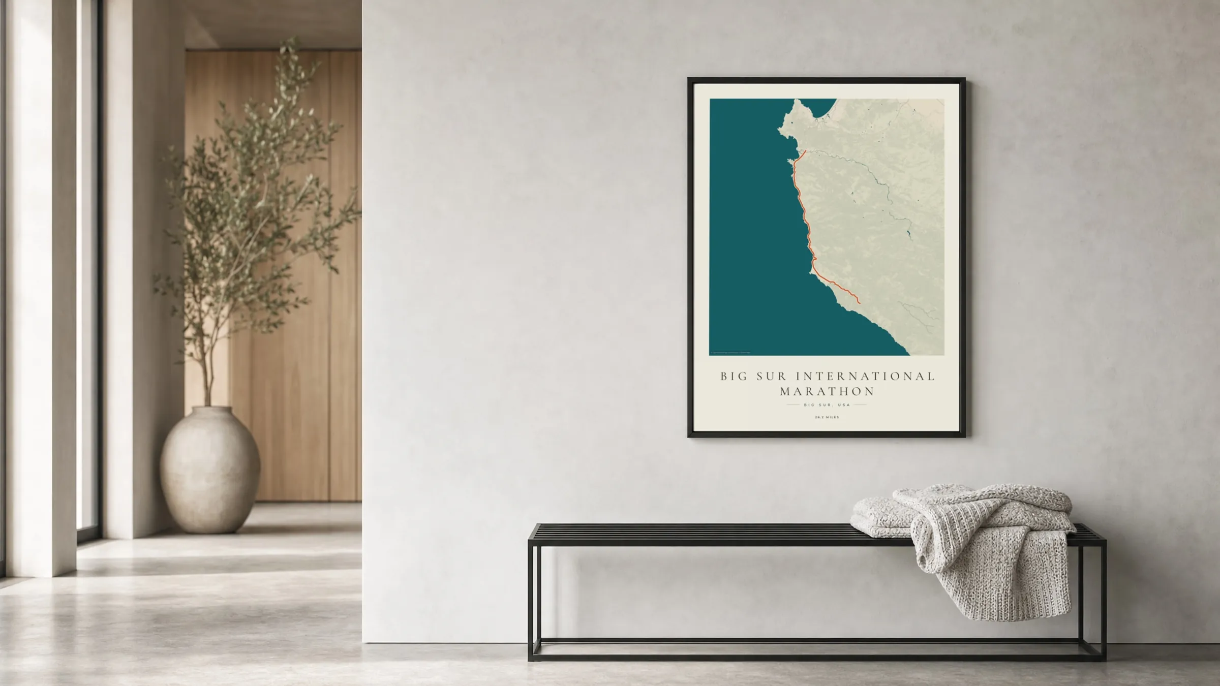Big Sur International Marathon 2026 Coastal Atlas route print in a black frame in a bright hallway