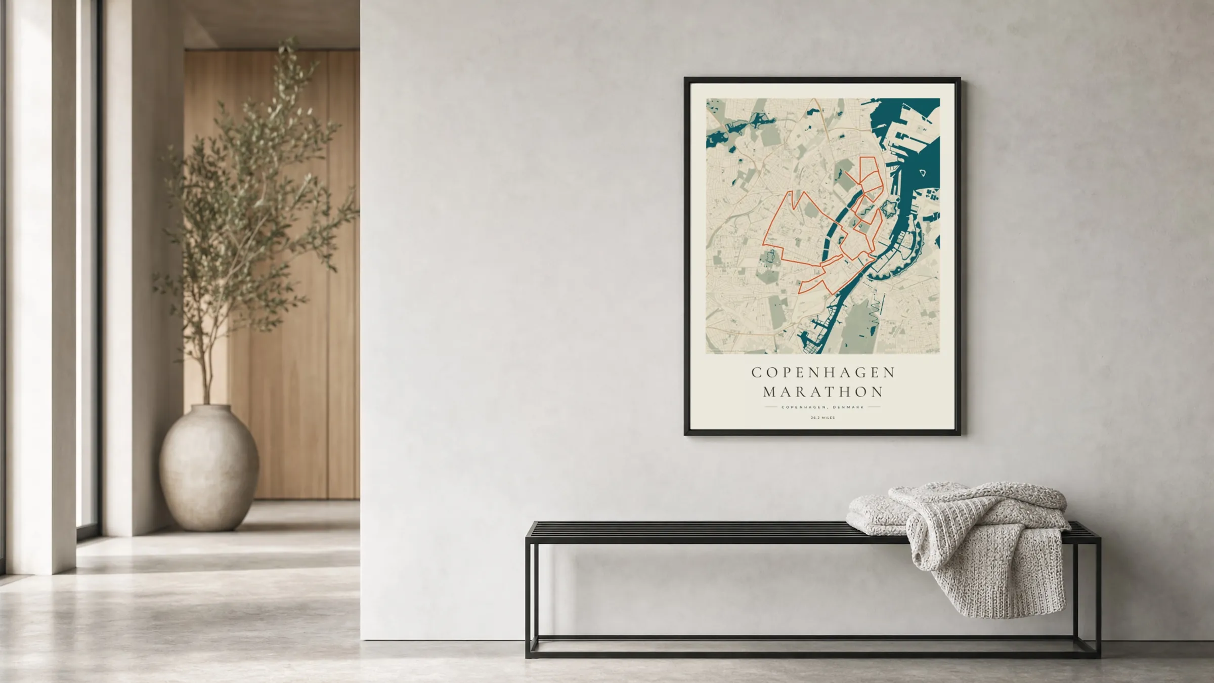 Copenhagen Marathon 2024 Coastal Atlas route print in a black frame in a bright hallway