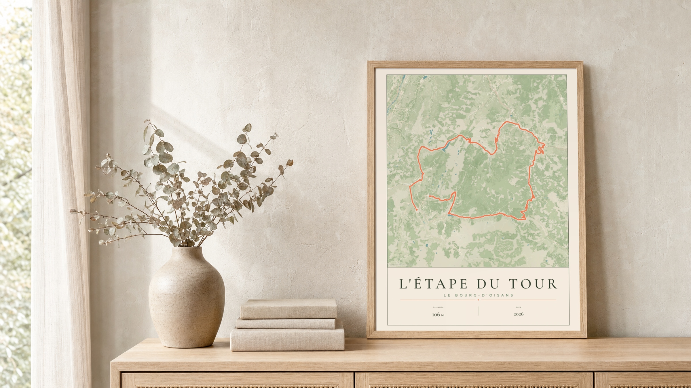 L'Étape du Tour 2026 Parkland route print in a light oak frame on a rattan console