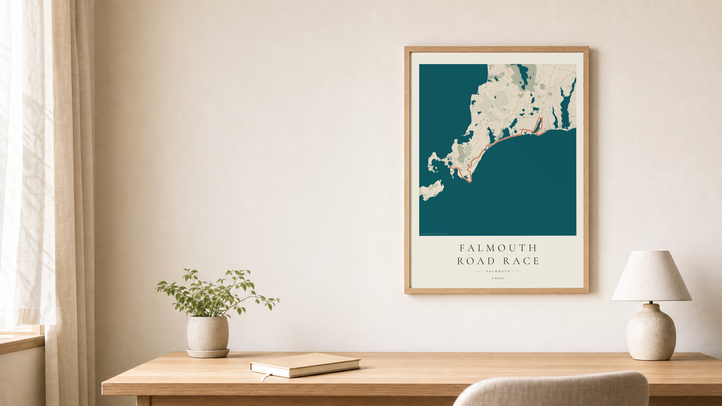 Falmouth Road Race 2026 Coastal Atlas route print in an oak frame above a study desk