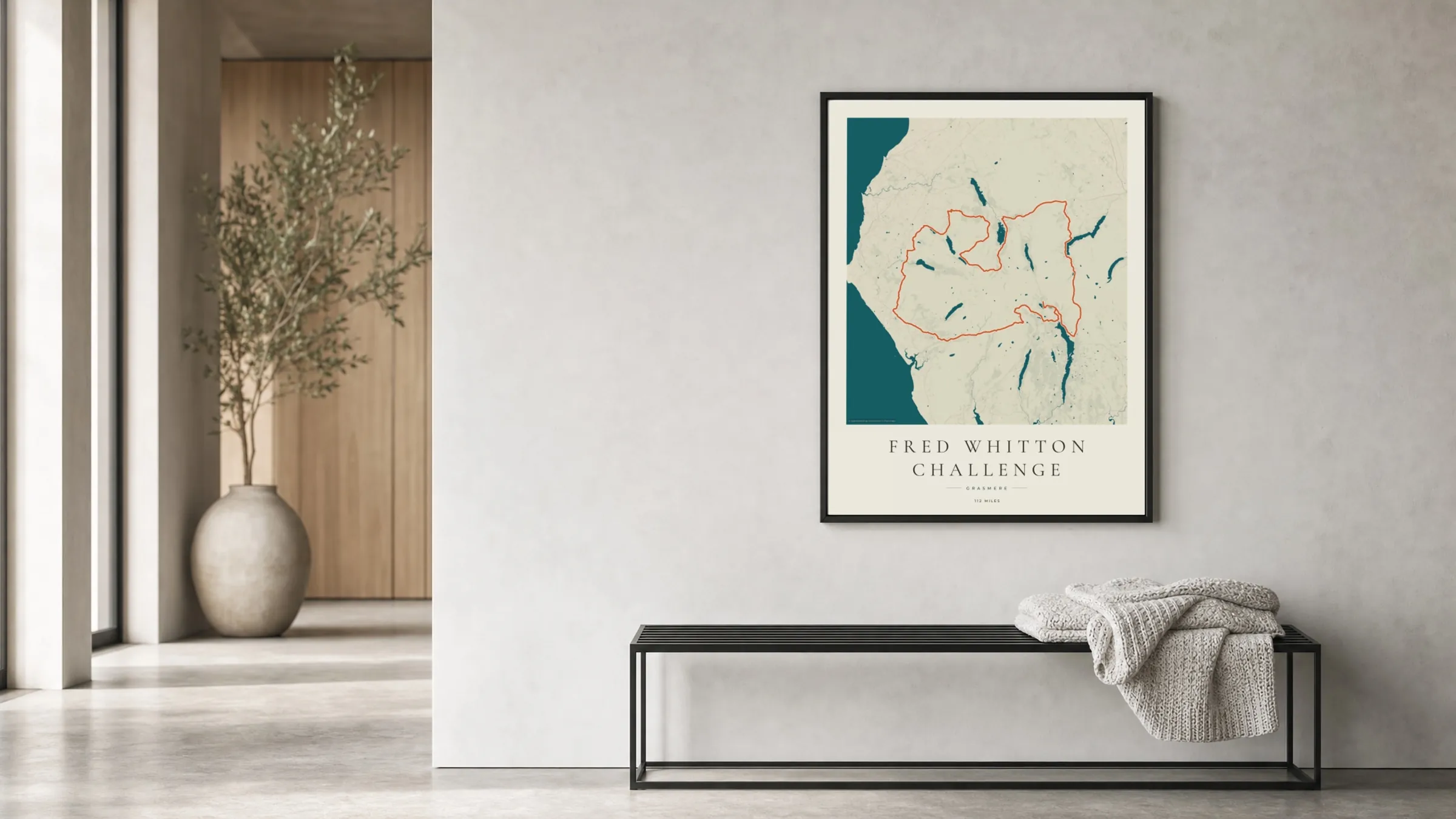 Fred Whitton Challenge 2027 Coastal Atlas route print in a black frame in a bright hallway