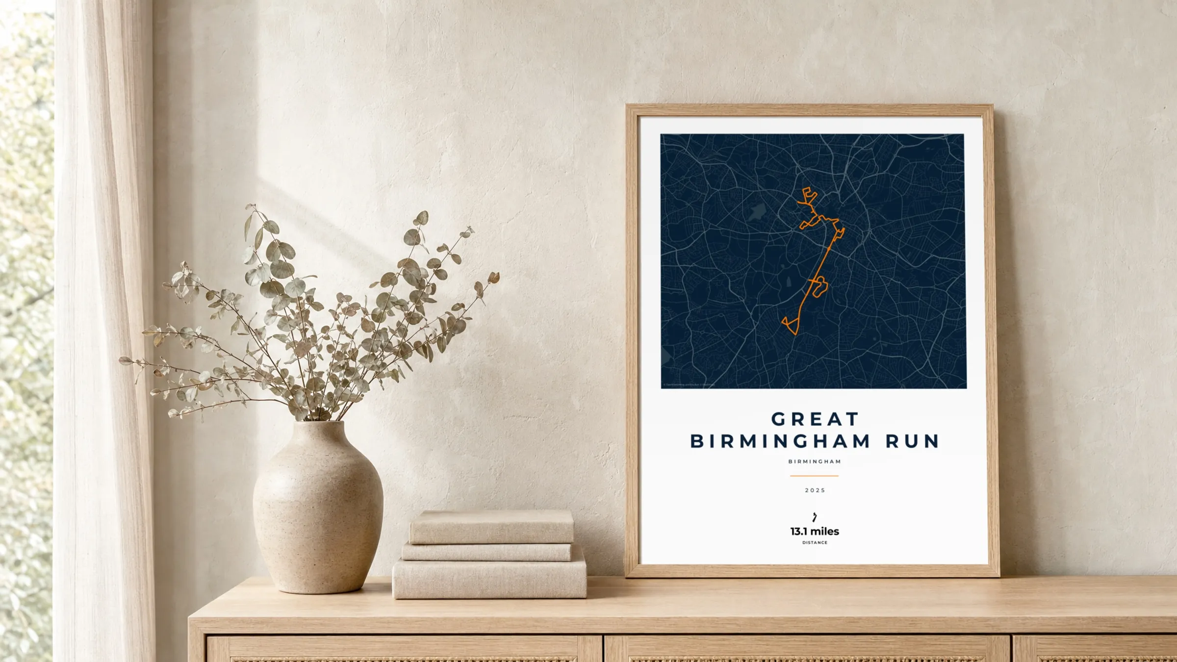 Great Birmingham Run 2025 Race Blueprint route print in a light oak frame on a rattan console