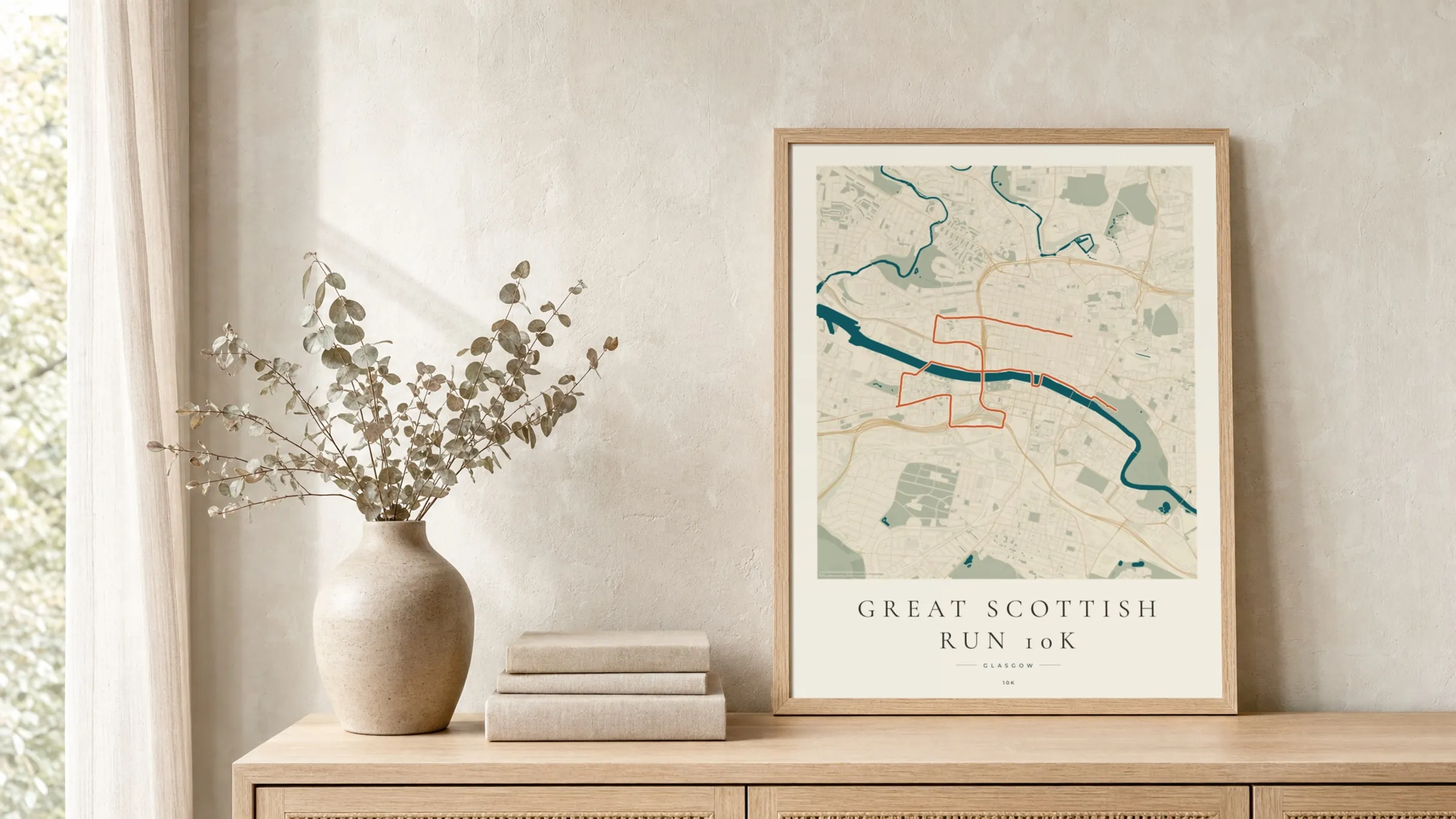 Great Scottish Run 10K 2025 Coastal Atlas route print in a light oak frame on a rattan console