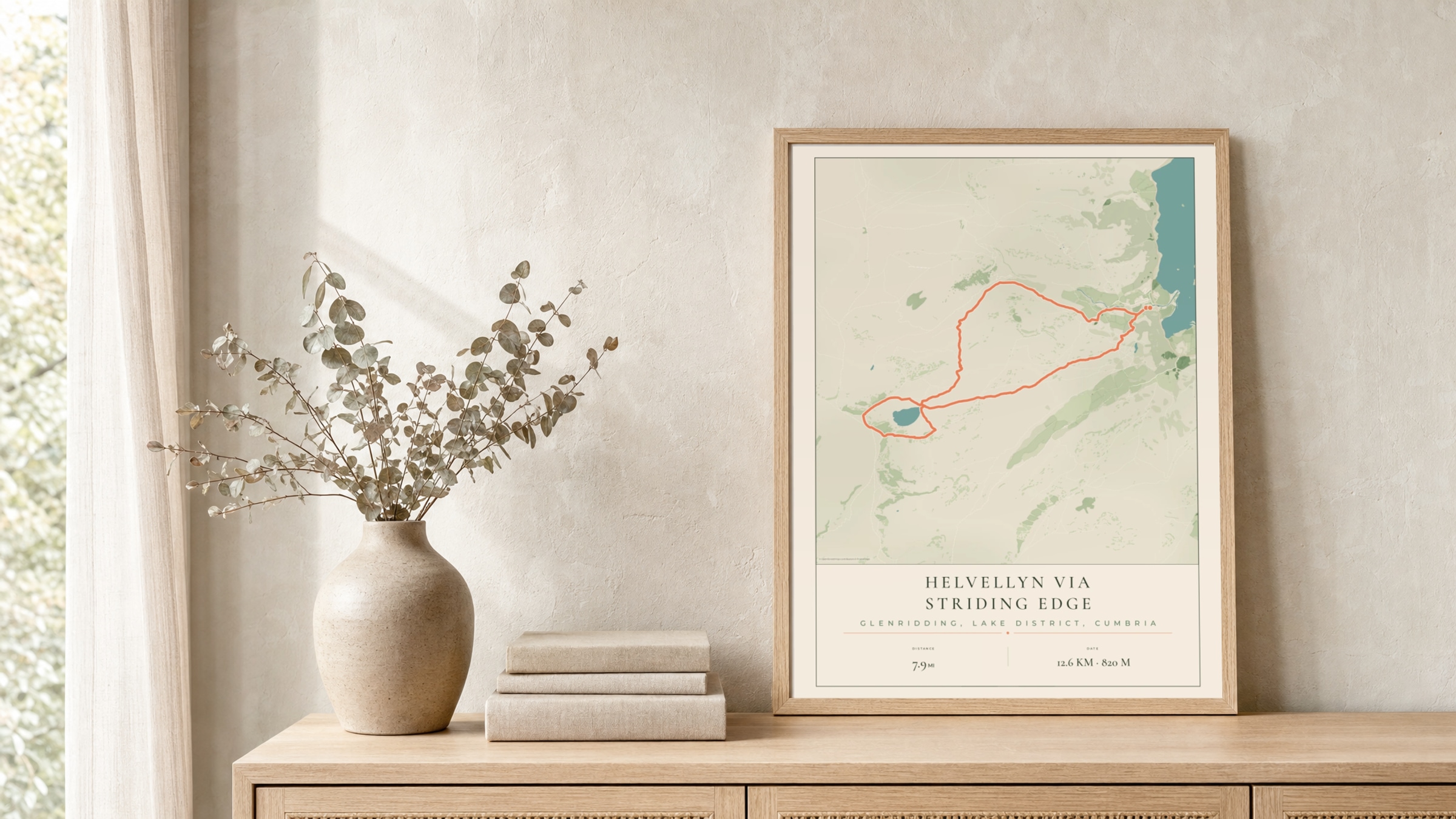 Helvellyn Parkland route print in a light oak frame on a rattan console