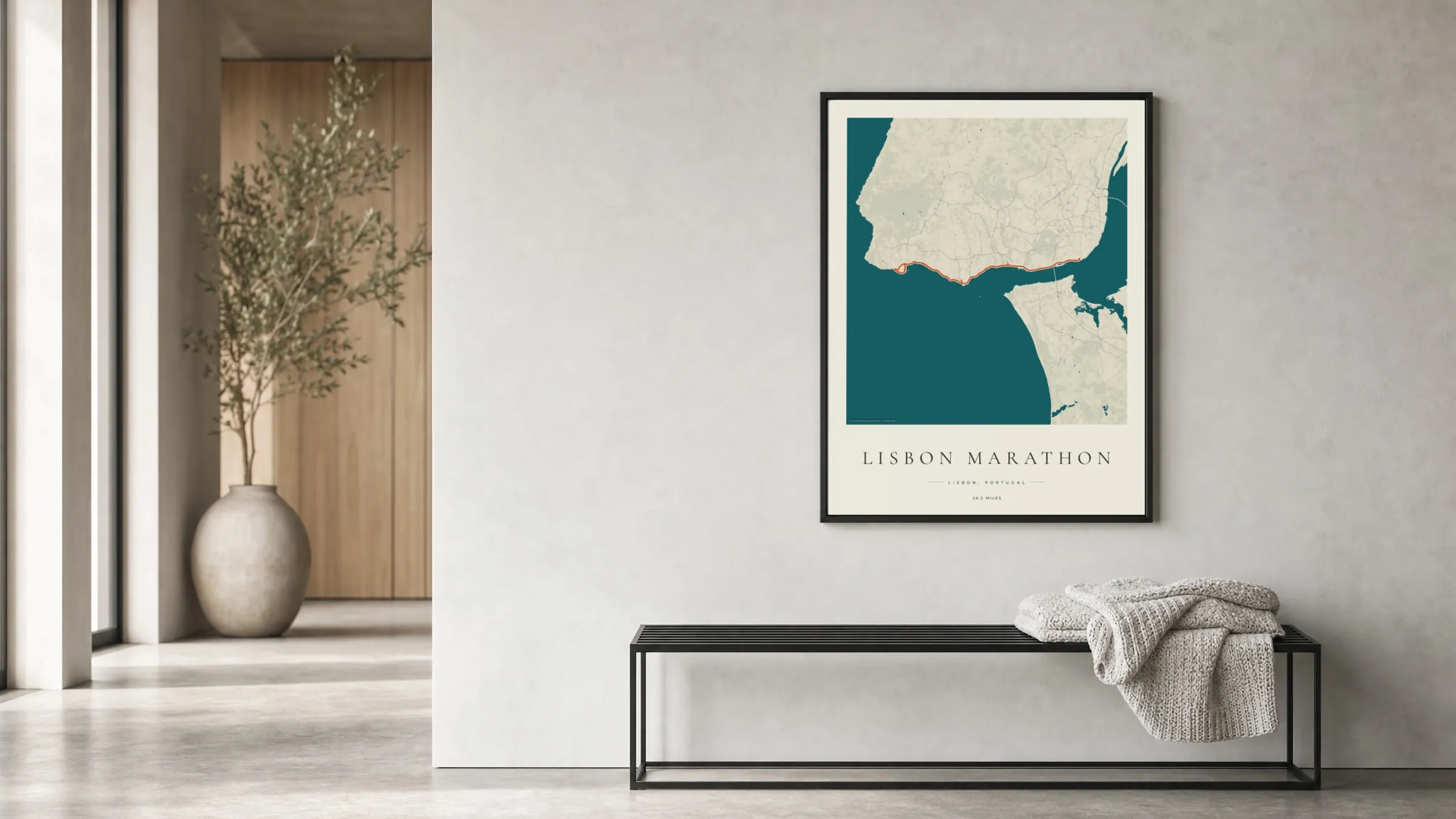 Lisbon Marathon 2025 Coastal Atlas route print in a black frame in a bright hallway