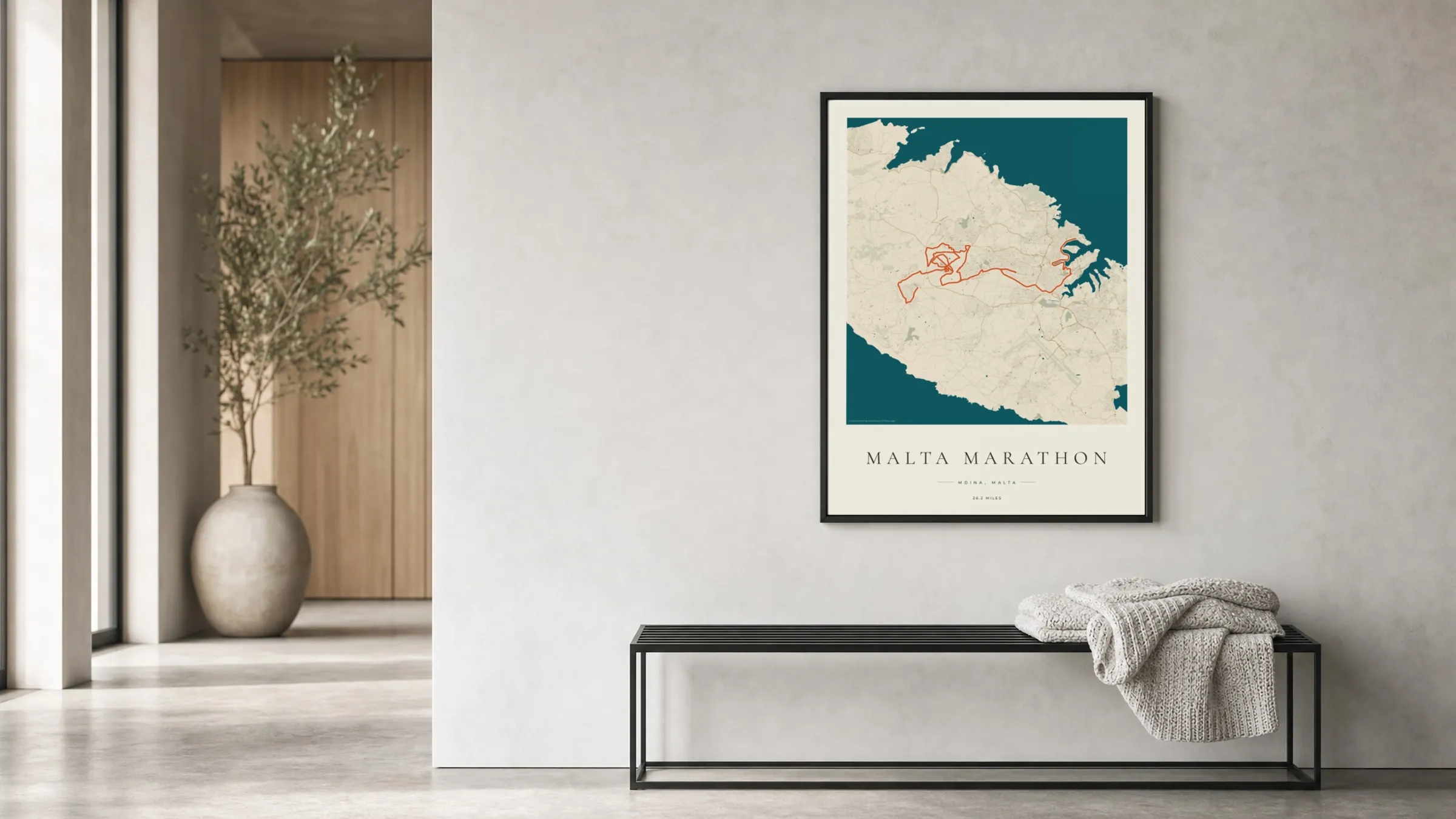 Malta Marathon 2025 Coastal Atlas route print in a black frame in a bright hallway