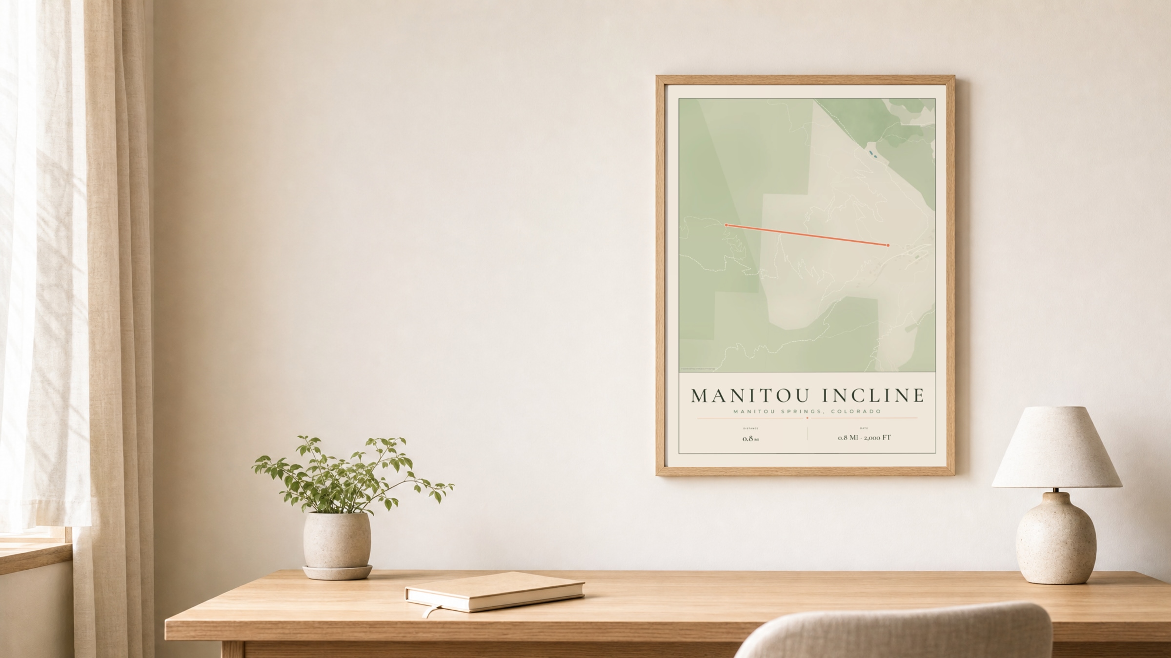 Manitou Incline Parkland route print in an oak frame above a study desk