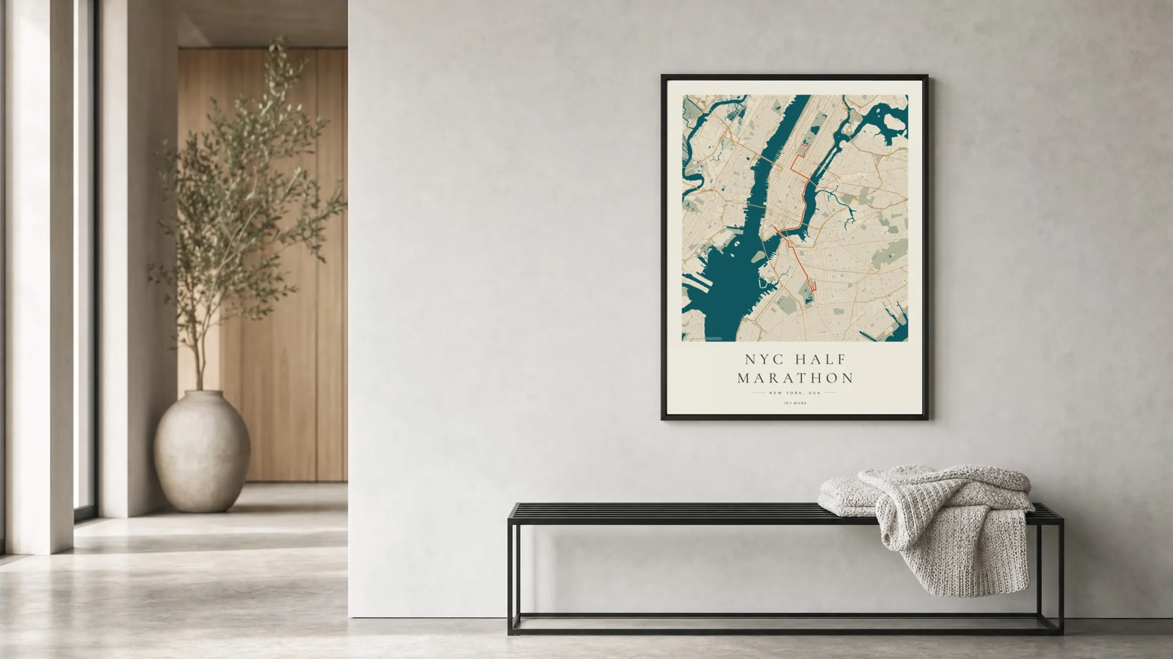 NYC Half Marathon 2026 Coastal Atlas route print in a black frame in a bright hallway