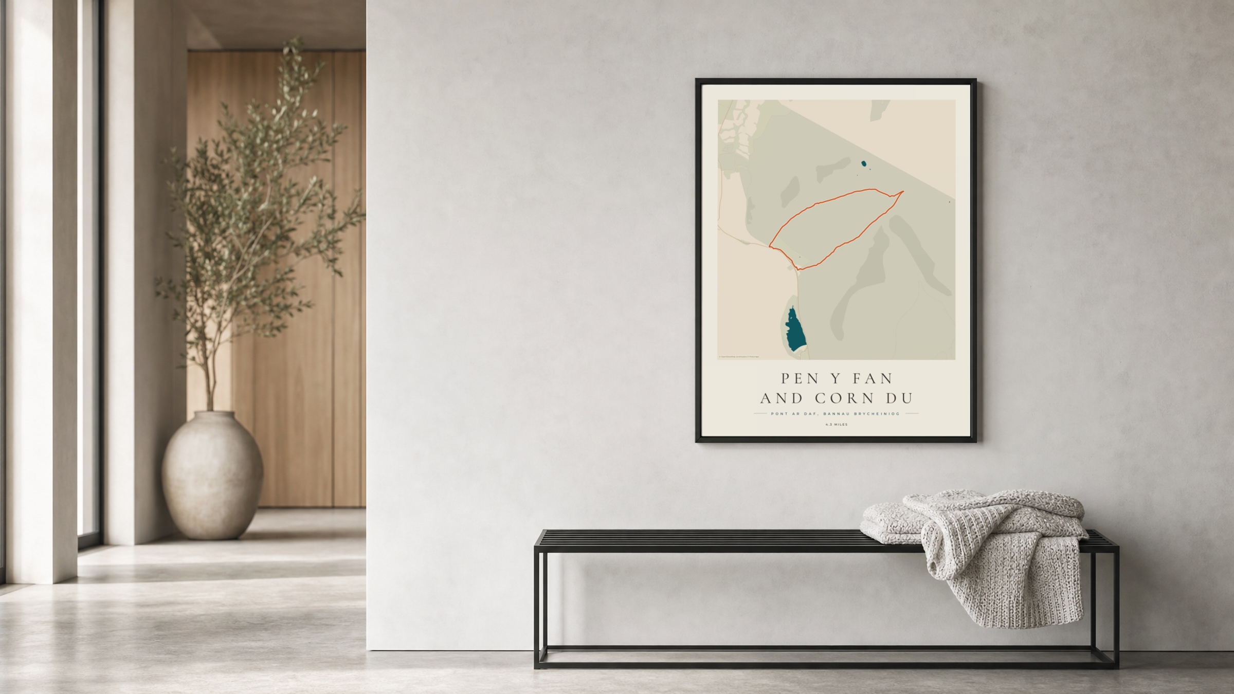 Pen y Fan Coastal Atlas route print in a black frame in a bright hallway