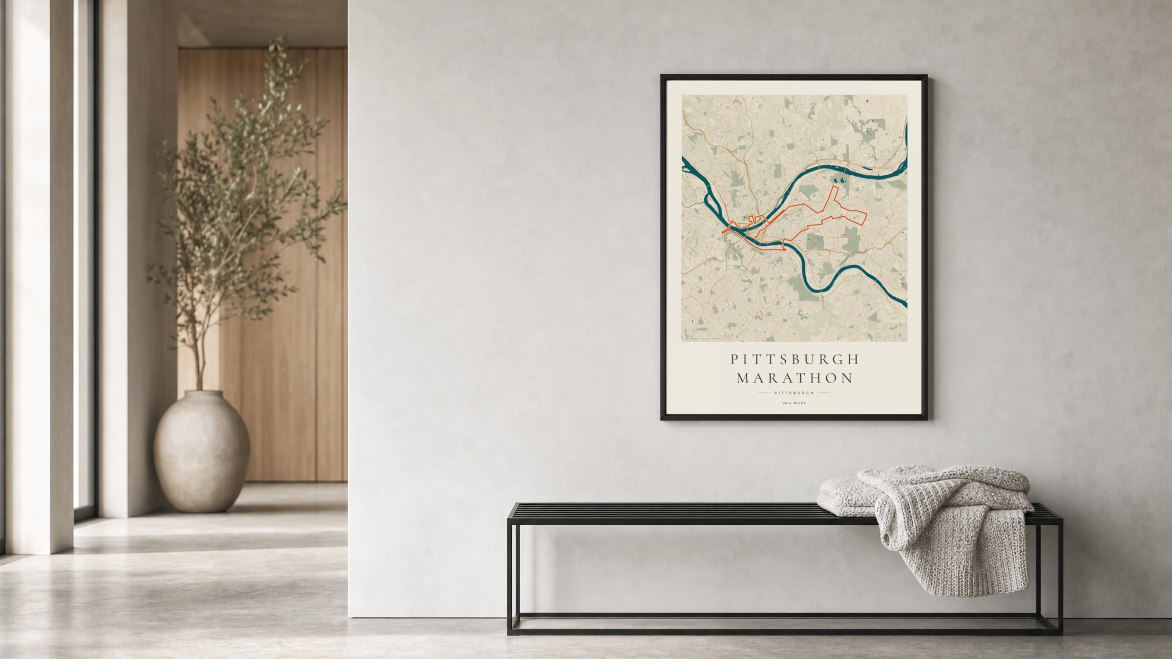 Pittsburgh Marathon 2025 Coastal Atlas route print in a black frame in a bright hallway