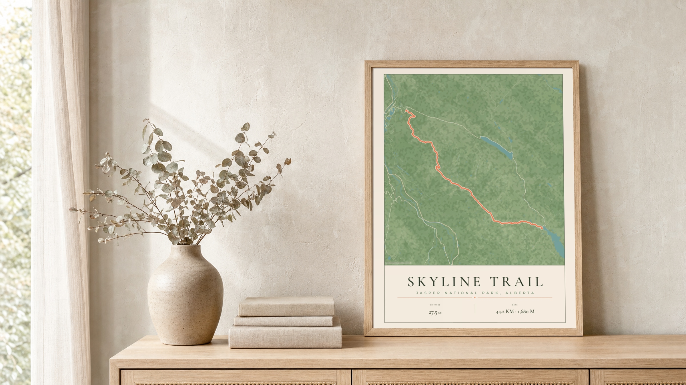 Skyline Trail Parkland route print in a light oak frame on a rattan console