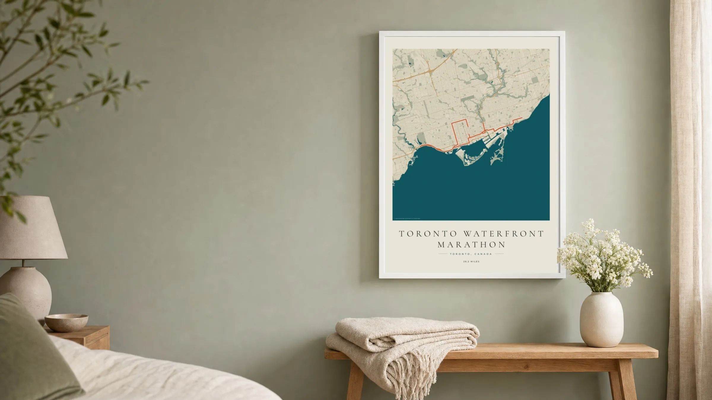 Toronto Waterfront Marathon 2025 Coastal Atlas route print in a white frame on a sage bedroom wall