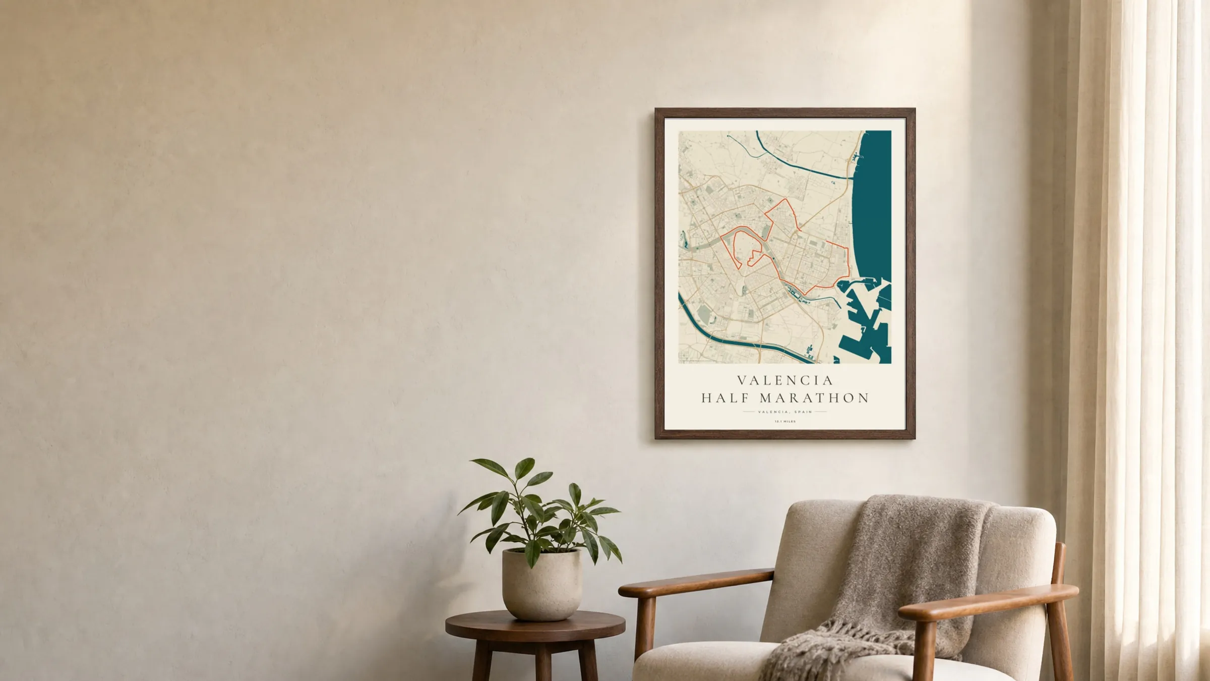 Valencia Half Marathon 2024 Coastal Atlas route print in a dark walnut frame on a living-room wall