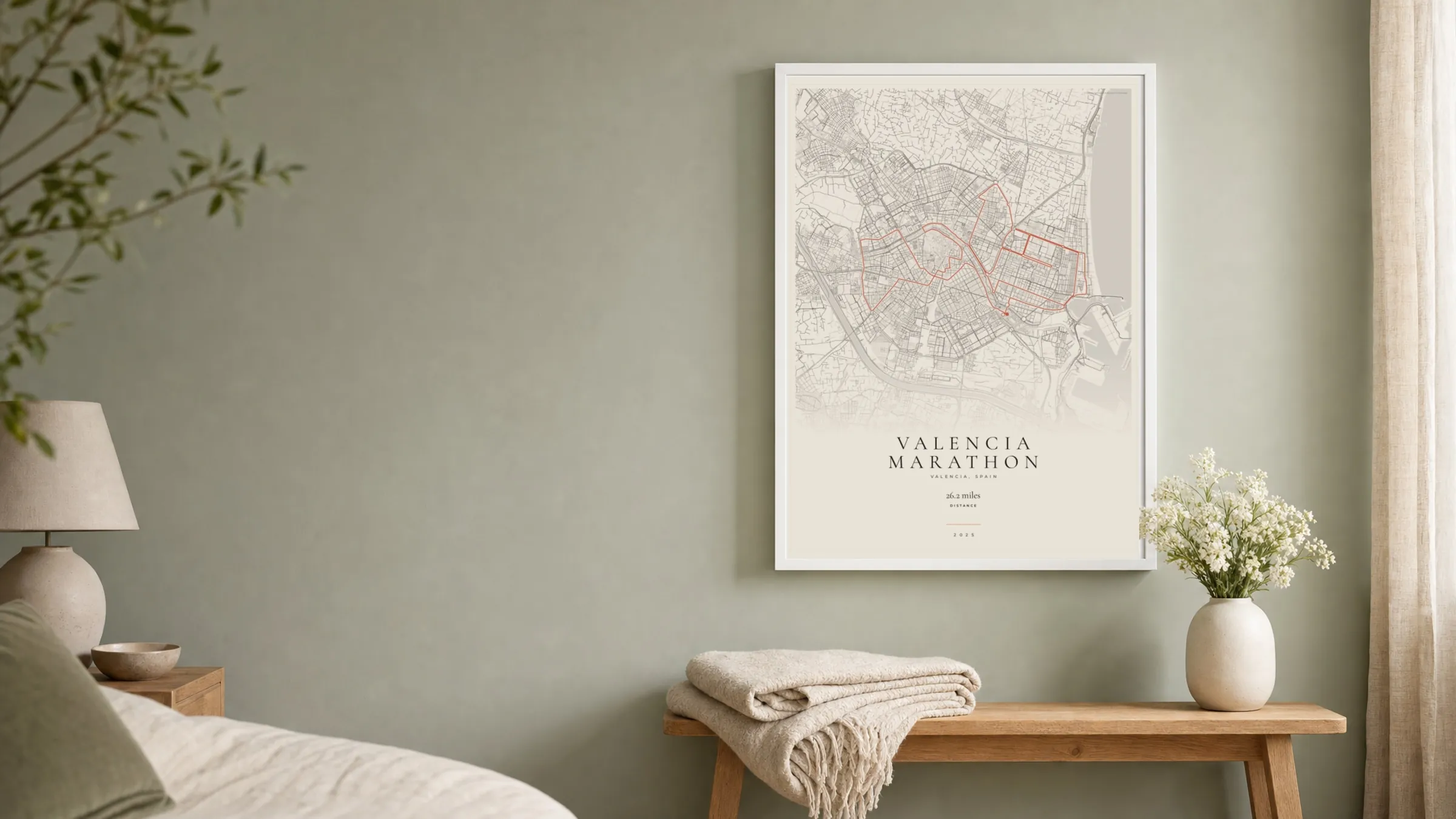 Valencia Marathon 2025 Gallery Mono route print in a white frame on a sage bedroom wall
