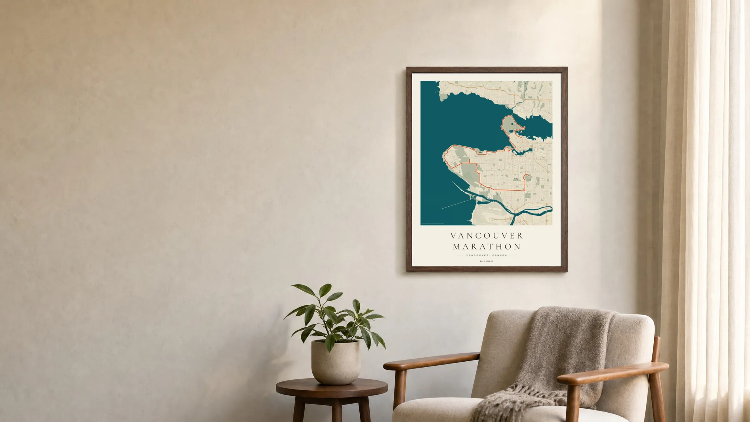 Vancouver Marathon 2025 Coastal Atlas route print in a dark walnut frame on a living-room wall
