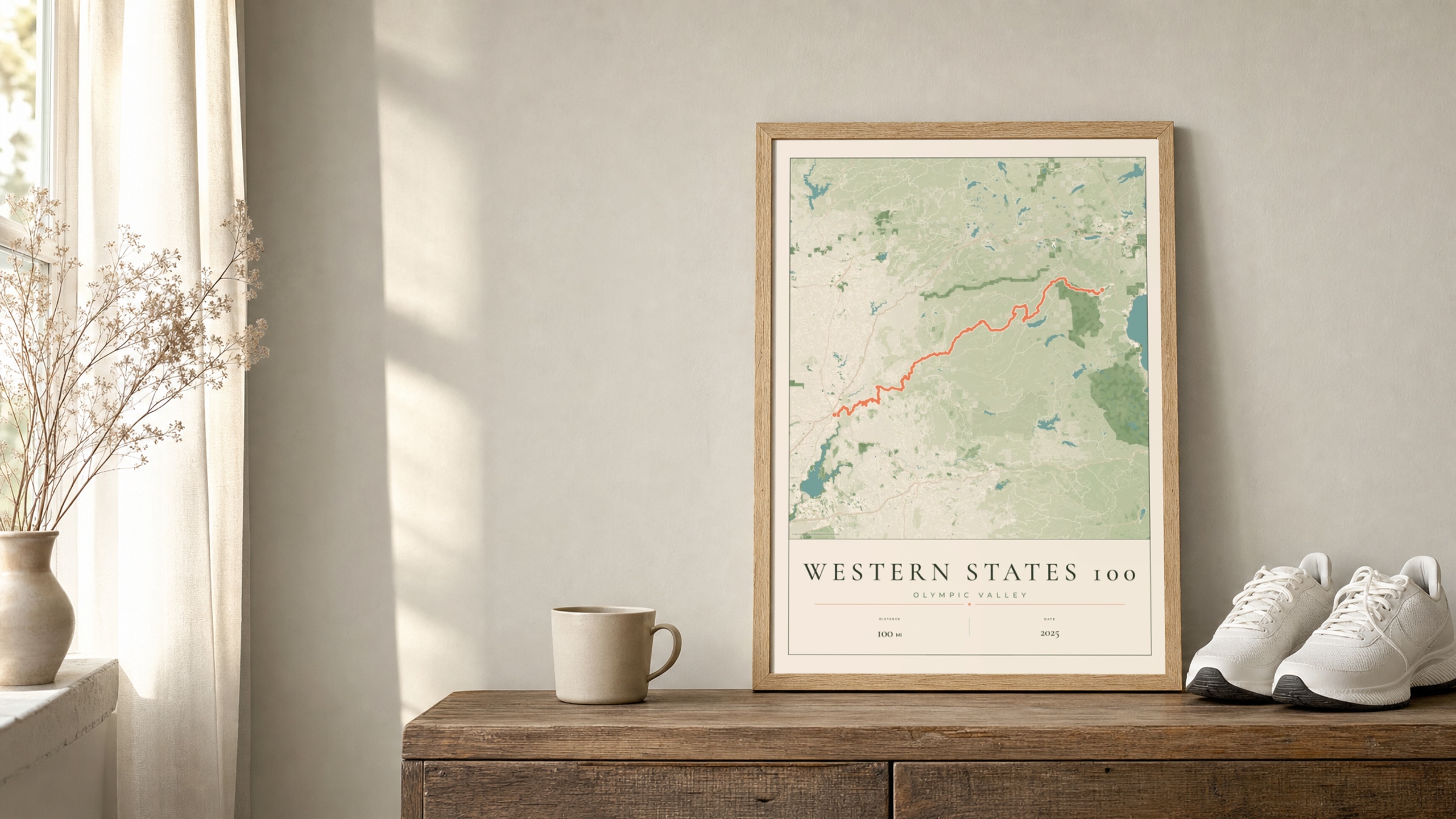 Western States 100 2025 Parkland route print in an oak frame on a sideboard beside running shoes